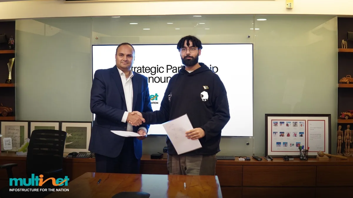 Adnan Zaidi, CEO of Multinet Pakistan, and Sherdil Ali Khan, CEO of World Context, shake hands at the partnership signing in Karachi
